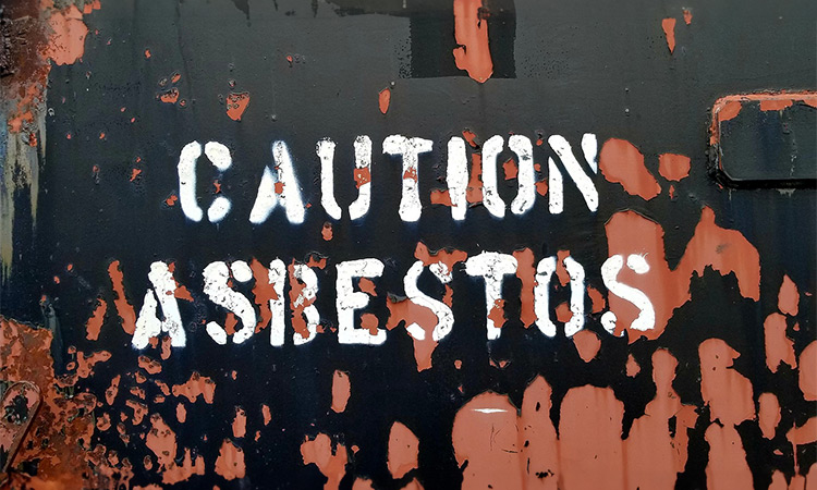 Caution Asbestos Spray Painted on Wall With Asbestos